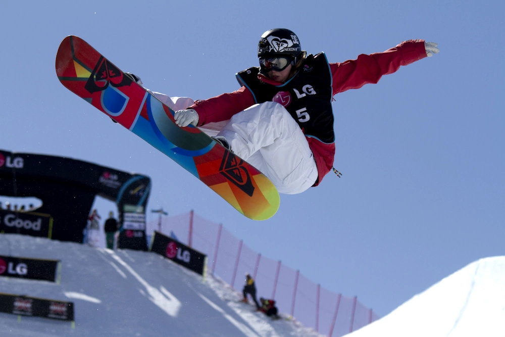 Snowboard dude competing in half-pipe