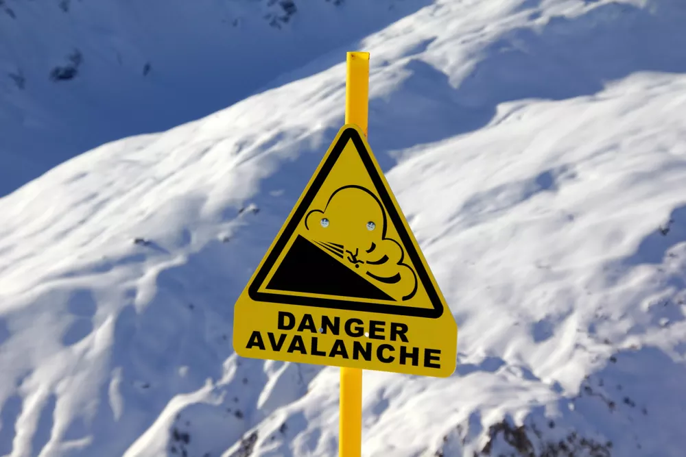 Yellow sign with avalanche warning
