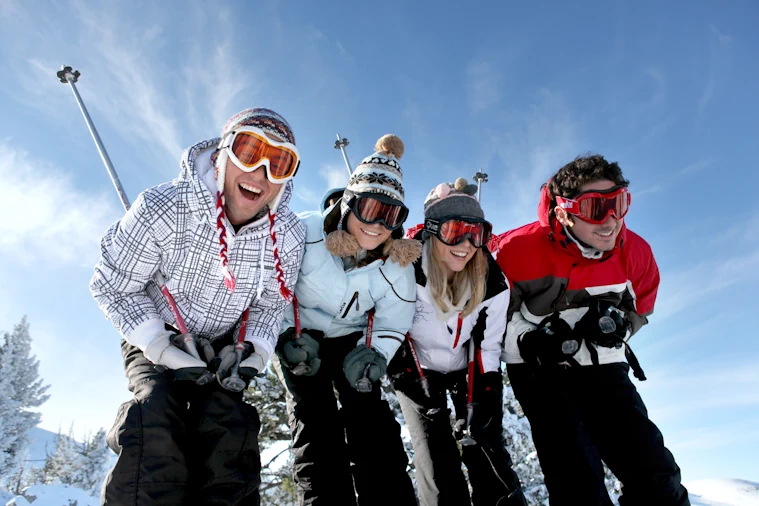 Happy skiers about to learn skiing